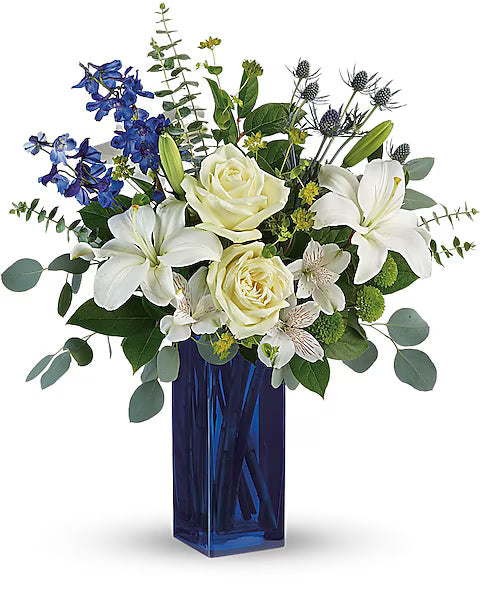 white and blue flowers in a blue vase