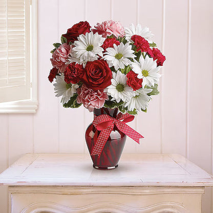 red, white, and pink flowers in a red vase