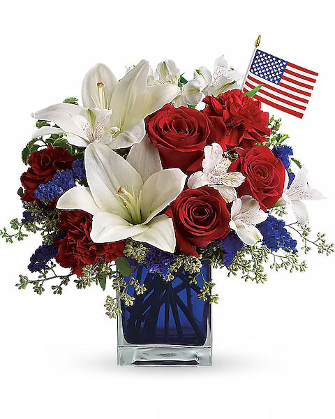 red, white, and blue flowers in a blue vase