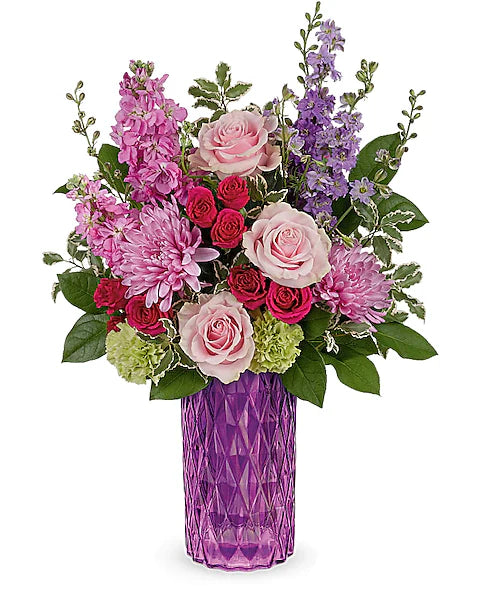 Colorful flower arrangement in a purple vase