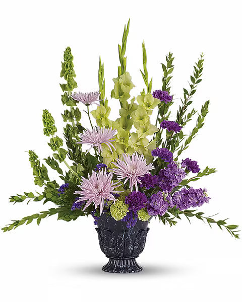 purple and green flowers in a decorative vase