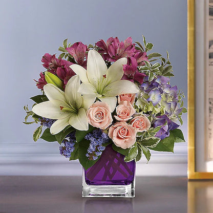 white lilies, pink roses, and purple hydrangeas